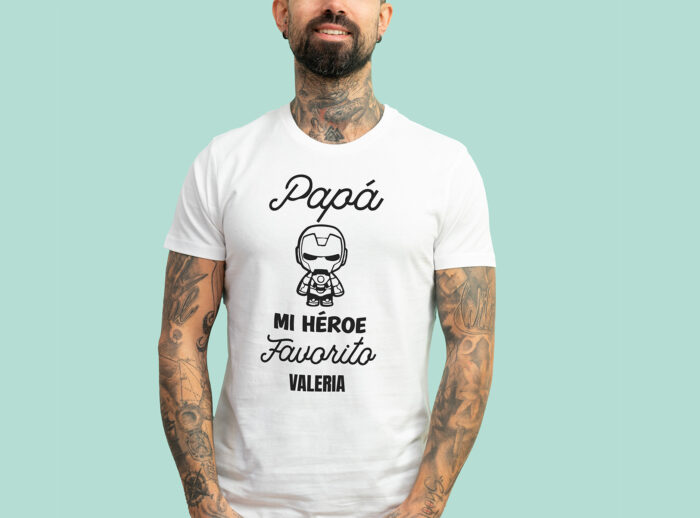 Camiseta blanca con la frase 'Papá, mi héroe favorito', adornada con un dibujo de un superhéroe y personalizada con el nombre que elijas.