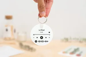 Llavero redondo personalizado con código Spotify, título de la canción y nombre del artista en un lado, y una imagen personalizada en el otro.