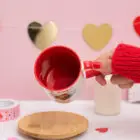 Taza de cerámica con el asa de corazón y el interior rojo. Personalizada con diseños de enamorados